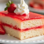 Beautiful strawberry jello cake with layered textures and elegant garnishes.